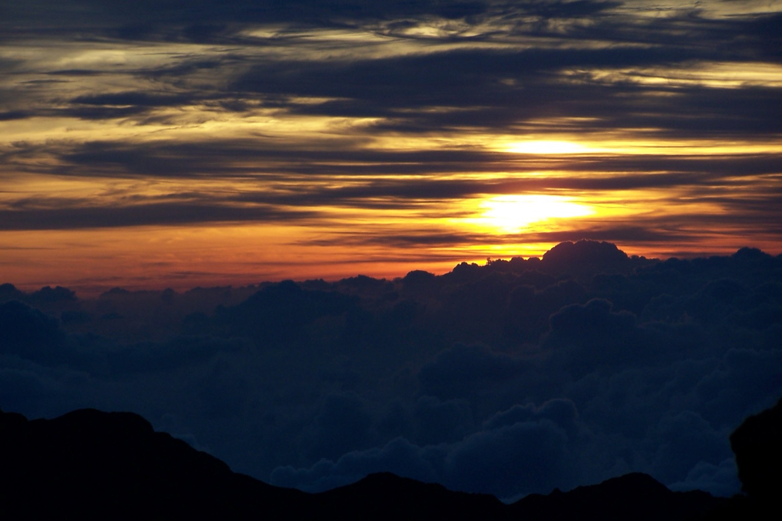 Sunrise above clouds from the summit of Haleakala in Maui